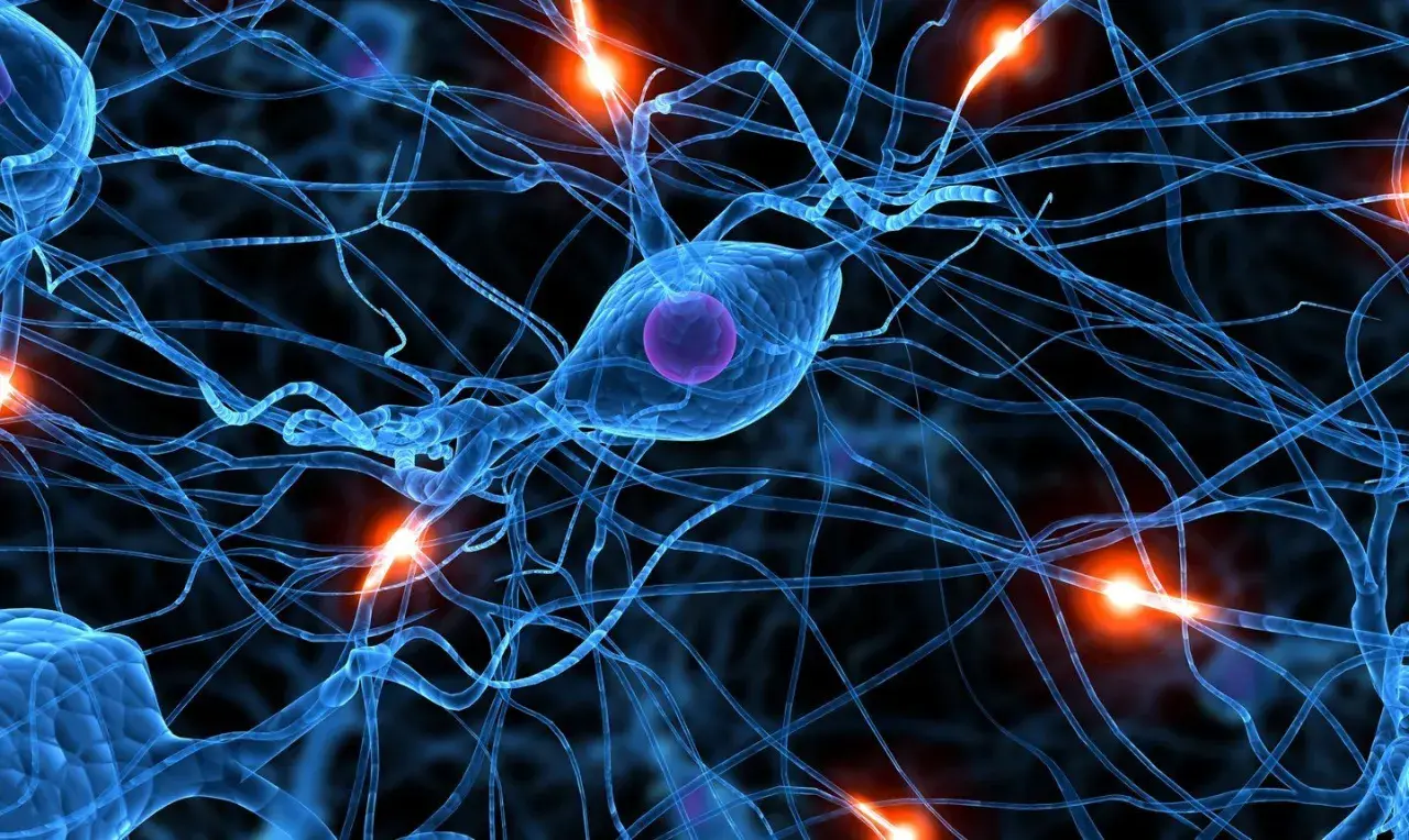 Neurones bleus interconnectés, avec des éclairs d'énergie orange. Une image qui évoque la complexité du cerveau, et la recherche sur la parkinson cause psychologique.